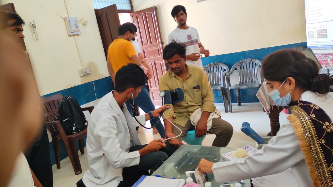 Blood pressure being checked at a village camp