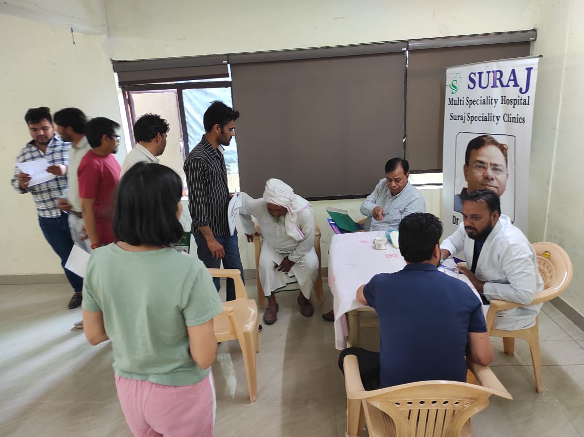 Patients queuing at the registration table of a health camp