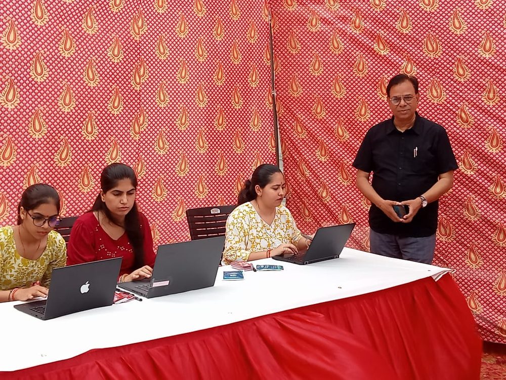 Volunteers working on laptops at a Foundation event